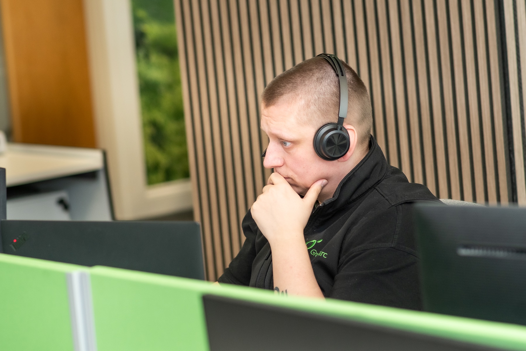 A Greenarc account support colleague helping customers by phone